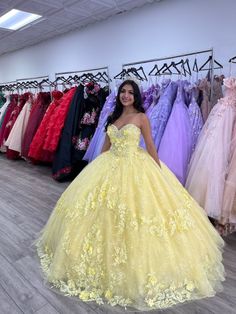 Radiate sunshine and elegance on your quinceanera with this breathtaking Yellow Ball Gown. This dress is crafted from luxurious tulle fabric and boasts a voluminous ball gown silhouette that creates a show-stopping effect, making you the center of attention as you enter the room. The romantic sweetheart neckline beautifully frames your chest, while the sleeveless design enhances the graceful, flowing lines of the gown. The Intricate appliqued details add a touch of artistry, elevating the dress Quiencera Dresses Yellow, Yellow Damas Dresses, Quinceñera Dresses Yellow, Yellow Theme Quinceanera, Qinsenara Dresses Yellow, Yellow And White Quinceanera Dress, Yellow Quincenera Dresses, Sweet 16 Yellow Dresses, Orange 15 Dresses Quinceanera