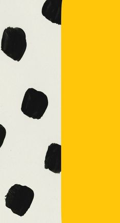 a yellow and white wall with black spots on it