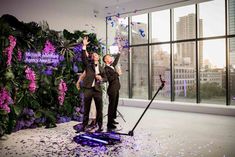 two men standing in front of a stage with confetti on it