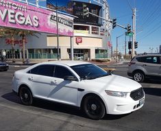 a white police car parked in front of a casino