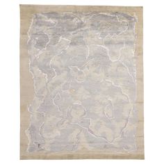 an old rug with white and grey colors on the bottom, in front of a white background