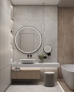 a bathroom with a large round mirror above the sink and a bathtub in front of it