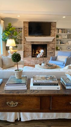 a living room filled with furniture and a flat screen tv mounted above a fire place