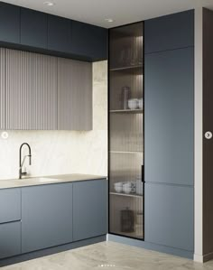 a kitchen with blue cabinets and white counter tops