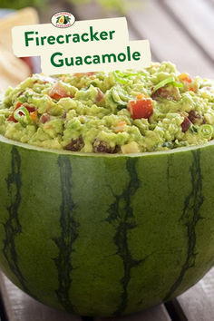 a large bowl filled with guacamole sitting on top of a wooden table