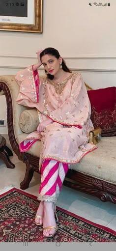 a woman sitting on top of a couch in a living room