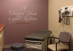 a medical room with a wall decal that says a cheerful heart is good medicine