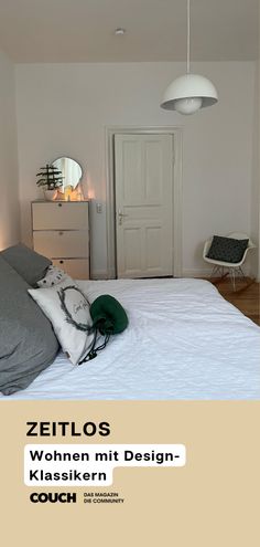 a white bed sitting in a bedroom next to a door