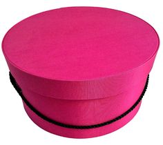 a pink round box with black string around it