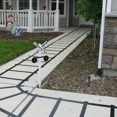 a railroad crossing in front of a house