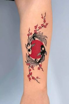 a woman's leg with a tattoo on it that is decorated with birds and flowers