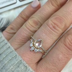 a woman's hand with a diamond ring on it