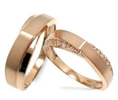 two gold wedding rings with diamonds on them