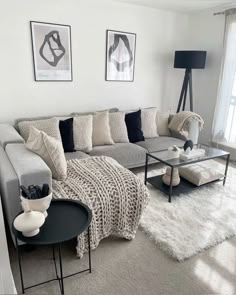 a living room filled with lots of furniture and pillows on top of a white rug