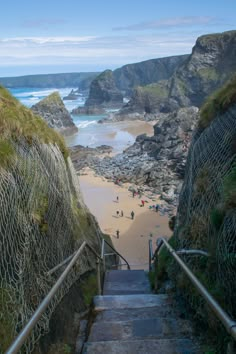 stairs lead down to the beach with people walking up them