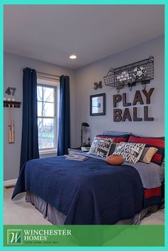 a bedroom with gray walls and blue bedding has pictures on the wall above it