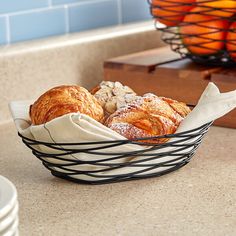 a basket filled with croissants sitting on top of a counter