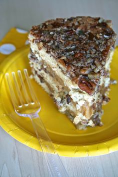 a yellow plate with a piece of cake on it and a fork next to it