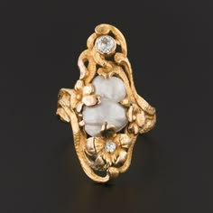 Pearls, one of nature's hidden treasures, remind us that often the most intense beauty lies within. This delightful baroque pearl ring dates to the early 1900s (circa 1900-1910). The ring is 14k gold with a floral motif and two diamond accents.  The larger of the two stones is an old European cut diamond with an estimated carat weight of 0.16ct.  The smaller diamond is mine cut.  The ring is a size 5.5 and in very good condition.  It can be re-sized free of charge.  We have many other fantastic Art Nouveau Rings, Pearl Diamond Ring, Art Nouveau Ring, Cute Engagement Rings, Pearl And Diamond Ring, Jewelry Post, Mom Jewelry, Vintage Jewels, Pearl Diamond