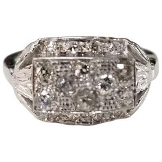 an antique style ring with diamonds on it