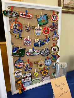 a bulletin board with pins and magnets attached to it on a blue table cloth