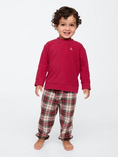 Soft knit pajama set.  Crewneck.  Long sleeves with banded cuffs.  Banded hem.  Brannan Bear with Gap logo graphics at front.  Elasticized waist at PJ joggers.  Allover plaid at PJ joggers.  This PJ set is made with 100% recycled polyester.  Compared to virgin materials, using recycled materials helps to reduce resource use and waste.  This product was made in a factory that runs the Gap Inc.  P. A. C. E.  Personal Advancement & Career Enhancement) program.  P. A. C. E.  is our educational progr Gap Logo, Pj Sets, Tartan Plaid, The Gap, Logo Graphic, Soft Knits, Recycled Materials, Pajama Set, Baby Toddler