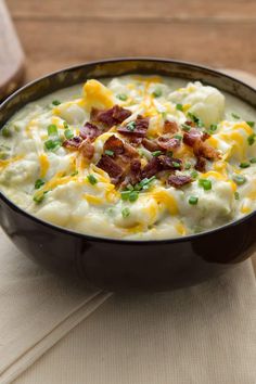 loaded baked potato soup in a black bowl