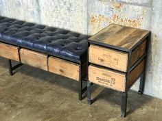 a bench made out of wooden crates with drawers on each side and an end table next to it