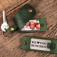 two keychains with the words we love you bunches printed on them and an image of three people holding each other