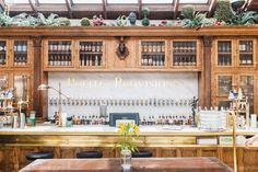 an old fashioned bar with lots of bottles on it