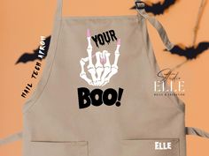 an apron with the word boo on it and two bats in the air behind it