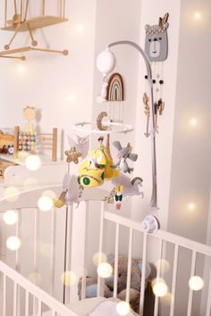 a baby crib with toys hanging from the ceiling