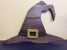 a purple wooden witch hat sitting on top of a table