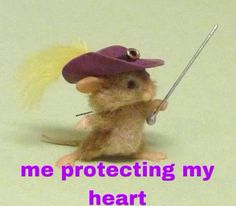 a little mouse with a purple hat holding a stick