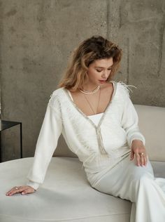 a woman sitting on top of a white couch