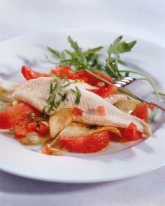 a white plate topped with fish and veggies