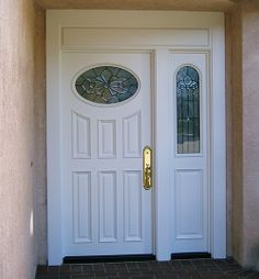 a white front door with stained glass windows