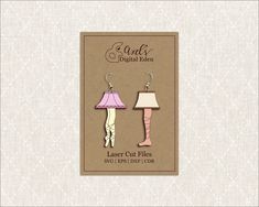 a pair of earrings with lamps on the front and back of them, both in different colors