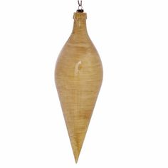 a wooden vase hanging from a string on a white background