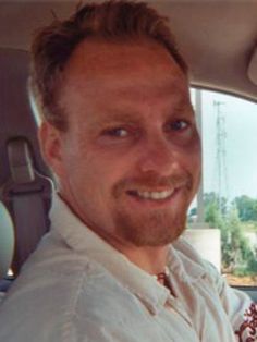 a man sitting in the back seat of a car