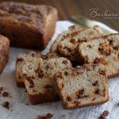 several pieces of bread sitting on top of a white napkin next to some chocolate chips