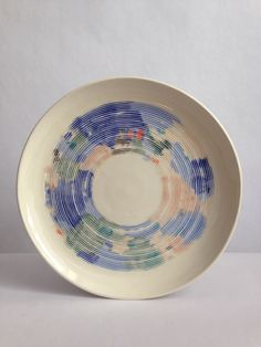 a white bowl with blue and red designs on it