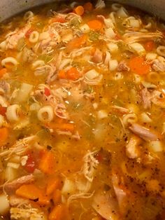 a pot filled with pasta and meat soup