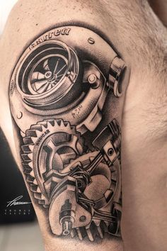 a man's arm with a clock and gears tattoo on it