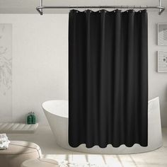 a bathroom with a bathtub, toilet and shower curtain in black and white colors