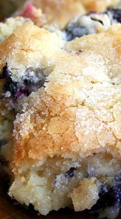 blueberry muffins are sitting on a cutting board