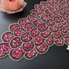 the table is covered with pink and black beads, which are embellished on top of each other