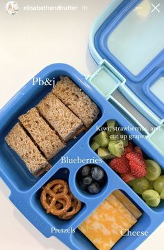 a blue lunch box filled with different types of food and pretzels on top of it