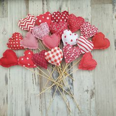 a bunch of red and white hearts on sticks