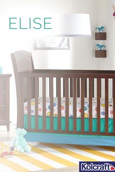 a baby crib in the corner of a room with a teddy bear on the floor